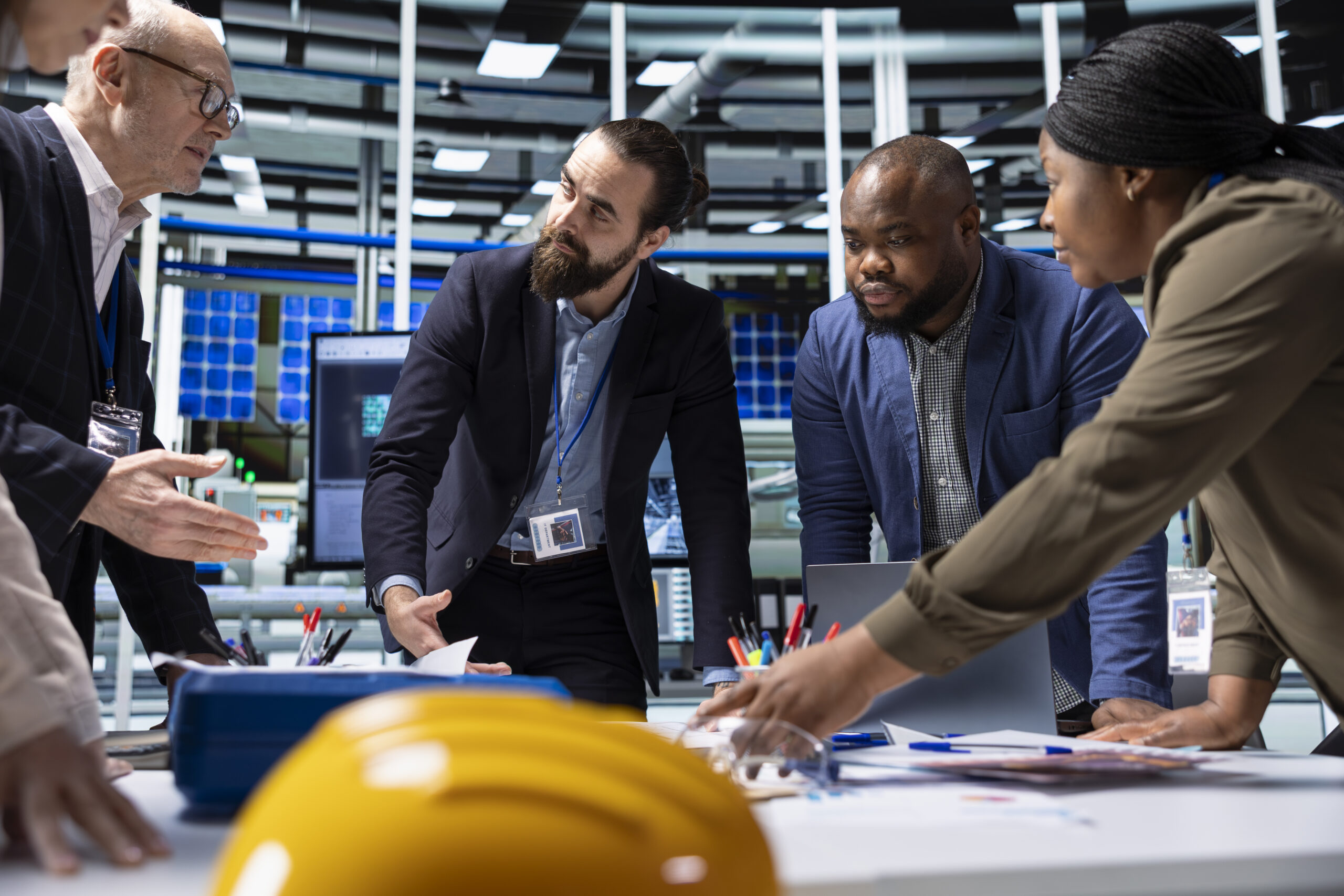 Factory management executives discuss research and development operational data
